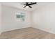 Bright bedroom with a ceiling fan, window, and wood-look flooring at 42 E 14Th St, Mesa, AZ 85201