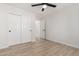 Bright bedroom with a ceiling fan, closet, and wood-look flooring at 42 E 14Th St, Mesa, AZ 85201