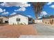 Charming single-story home with a freshly graveled front yard and a concrete driveway and walkway at 42 E 14Th St, Mesa, AZ 85201