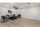 This living room features a ceiling fan, modern furniture, light wood floors, and minimalist decor at 42 E 14Th St, Mesa, AZ 85201