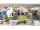 A view of a beige tile roof home, showcasing desert landscaping and a concrete driveway at 42829 N Livingstone Way, Anthem, AZ 85086