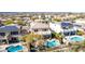 Aerial view of the backyard with a private pool, desert landscaping, and multiple homes with solar panels at 42829 N Livingstone Way, Anthem, AZ 85086