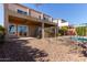 Backyard featuring a covered patio, a view of a shimmering pool, desert plants, and a gravel yard at 42829 N Livingstone Way, Anthem, AZ 85086