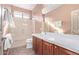 Well-lit bathroom with dark wood cabinetry and a white countertop with a shower and a toilet at 42829 N Livingstone Way, Anthem, AZ 85086