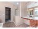 Bright bathroom featuring a glass enclosed shower, dark wood cabinetry, and double sinks at 42829 N Livingstone Way, Anthem, AZ 85086