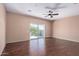 Bright bedroom with hardwood floors and sliding doors leading to balcony at 42829 N Livingstone Way, Anthem, AZ 85086