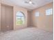 Neutral bedroom with a vaulted window, carpet floors, and a ceiling fan at 42829 N Livingstone Way, Anthem, AZ 85086