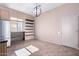 Bright dining area features wine rack, display shelves, and modern globe chandelier at 42829 N Livingstone Way, Anthem, AZ 85086