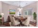 Dining room featuring hardwood floors, neutral paint, and a brown table with beige chairs at 42829 N Livingstone Way, Anthem, AZ 85086