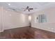 Large living room featuring hardwood floors, a ceiling fan, and a large window at 42829 N Livingstone Way, Anthem, AZ 85086