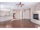 Spacious living room with hardwood floors, a fireplace, and ceiling fan at 42829 N Livingstone Way, Anthem, AZ 85086