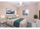 Comfortable main bedroom featuring a large window and a bed with an upholstered headboard at 42829 N Livingstone Way, Anthem, AZ 85086