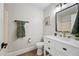 Well-appointed bathroom with a vanity, black mirror, and wood-look flooring at 43819 W Wolf Dr, Maricopa, AZ 85138