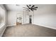 Spacious carpeted bedroom with modern ceiling fan and en-suite bathroom at 43819 W Wolf Dr, Maricopa, AZ 85138