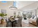 Bright dining area featuring hardwood floors, modern chandelier, and an open-concept layout at 43819 W Wolf Dr, Maricopa, AZ 85138