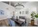 Dining area featuring hardwood floors, modern lighting, and comfortable seating at 43819 W Wolf Dr, Maricopa, AZ 85138