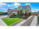 Landscaped front yard featuring an artificial lawn and stone ground cover at 43819 W Wolf Dr, Maricopa, AZ 85138