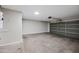 Spacious garage providing ample parking and storage solutions with a functional overhead door at 43819 W Wolf Dr, Maricopa, AZ 85138