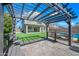 Charming outdoor pergola with seating area overlooking a lush green lawn and a glimpse of the refreshing pool at 43819 W Wolf Dr, Maricopa, AZ 85138