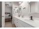 Bright bathroom featuring double sinks, modern faucets, and white cabinetry at 450 E Alamosa Dr, Chandler, AZ 85249