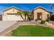 Charming single-story home featuring desert landscaping, a green lawn, and a two-car garage at 450 E Alamosa Dr, Chandler, AZ 85249