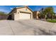 Exterior view of a two-car garage and driveway, with partial view of desert landscaping at 450 E Alamosa Dr, Chandler, AZ 85249