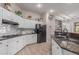 Bright kitchen featuring white cabinets, black appliances, and a stylish subway tile backsplash at 450 E Alamosa Dr, Chandler, AZ 85249