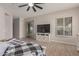 Light-filled main bedroom showcasing a TV, a ceiling fan, and luxury vinyl plank flooring at 450 E Alamosa Dr, Chandler, AZ 85249