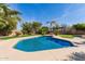 Gorgeous pool with a Baja shelf, set amongst palm trees, manicured landscaping and a putting green at 450 E Alamosa Dr, Chandler, AZ 85249