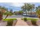 Scenic street view showcasing a community lake, mature trees, and lush landscaping at 450 E Alamosa Dr, Chandler, AZ 85249