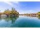 A captivating waterfront view features boats docked along the canal, mature trees, and beautiful architecture at 450 E Alamosa Dr, Chandler, AZ 85249