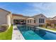 Backyard pool surrounded by lush artificial turf and features a patio and outdoor seating, perfect for entertaining at 4684 N 206Th Ave, Buckeye, AZ 85396