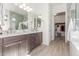 Bright bathroom features a double sink vanity, walk-in shower, and a well-organized walk-in closet at 4684 N 206Th Ave, Buckeye, AZ 85396