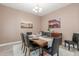 Elegant dining room boasts a rustic wood table, seating for six, and decorative wall art at 4684 N 206Th Ave, Buckeye, AZ 85396