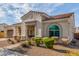 Attractive single-story home featuring desert landscaping, a tile roof and an inviting front porch at 4684 N 206Th Ave, Buckeye, AZ 85396