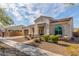 Elegant single-story home boasts a tile roof, desert landscaping and a welcoming front porch at 4684 N 206Th Ave, Buckeye, AZ 85396