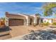 Inviting exterior with a three-car garage, tile roof, solar panels, and low-maintenance desert landscaping at 4684 N 206Th Ave, Buckeye, AZ 85396