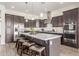 Gourmet kitchen with stainless steel appliances, an island with seating, and stylish pendant lighting at 4684 N 206Th Ave, Buckeye, AZ 85396