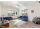 Bright living room featuring a sofa, guest bed, ceiling fan, and tile flooring at 4684 N 206Th Ave, Buckeye, AZ 85396