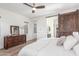 Serene main bedroom with wood-look floors, sliding barn door leading to ensuite bath, and large window at 4684 N 206Th Ave, Buckeye, AZ 85396