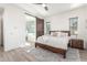 Serene main bedroom features a king bed, ensuite bathroom with a soaking tub, and wood-look floors at 4684 N 206Th Ave, Buckeye, AZ 85396