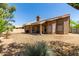 Spacious backyard featuring a covered patio and desert landscaping at 5009 E Baker Dr, Cave Creek, AZ 85331