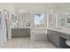 Bright bathroom with dual sinks, white cabinets, and garden tub with large picture window at 5009 E Baker Dr, Cave Creek, AZ 85331