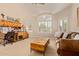 Comfortable living room with a ceiling fan, tray ceiling, large windows, and a cozy couch at 5009 E Baker Dr, Cave Creek, AZ 85331