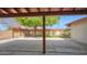 Covered back patio offers views of the well-maintained backyard and mature landscaping at 5216 W Beryl Ave, Glendale, AZ 85302