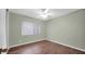 Cozy bedroom features hardwood floors, a large window, and natural light at 5216 W Beryl Ave, Glendale, AZ 85302