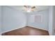 A blue bedroom that features hardwood floors and a ceiling fan at 5216 W Beryl Ave, Glendale, AZ 85302