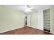 Bedroom showcasing hardwood floors, a sliding closet, and a view to another room at 5216 W Beryl Ave, Glendale, AZ 85302