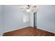 Bedroom showcasing hardwood floors, a sliding closet, and a bright blue wall at 5216 W Beryl Ave, Glendale, AZ 85302