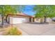 Lovely single-story home with a brick exterior, a two-car garage, and a well-kept lawn at 5216 W Beryl Ave, Glendale, AZ 85302